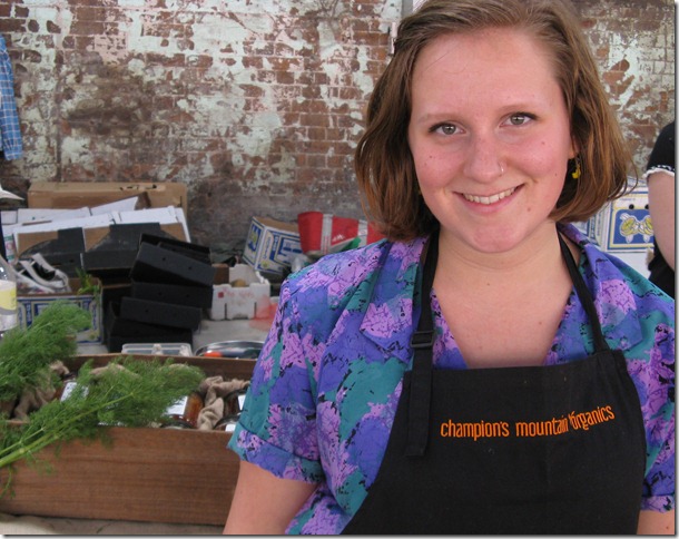 Katie in front of the Champion's Mountain Organics stall at Eveleigh Markets